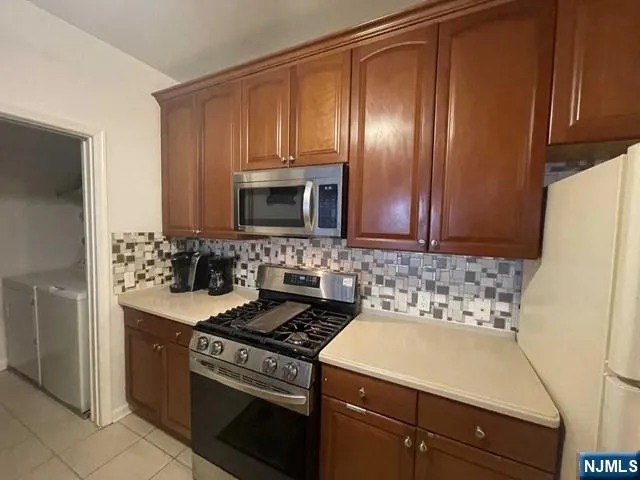 a kitchen with a sink stove and microwave