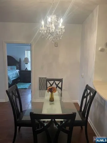 a view of a dining room with furniture and chandelier