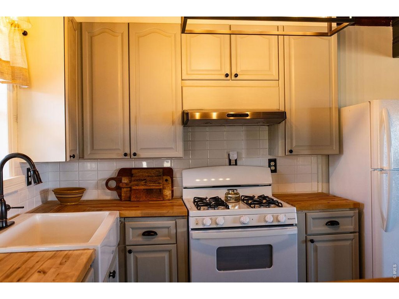 218 Pershing Street Grover, CO 80729 - Photo 14 of 50 Charming Country Kitchen with Modern Updates, Designer Lighting, and Farmhouse Sink