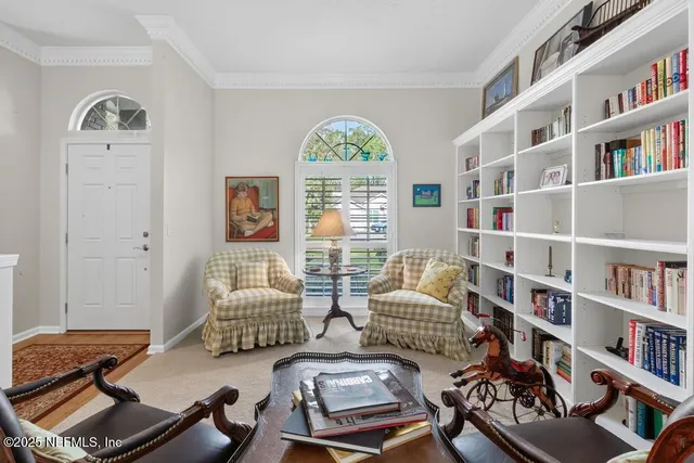 a living room with furniture ceiling fan and a rug