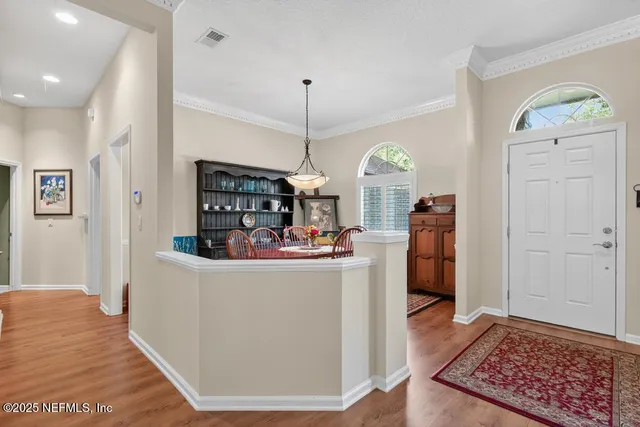 a view of a dining room with furniture window and wooden floor