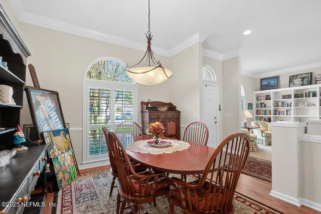 a kitchen with stainless steel appliances granite countertop a refrigerator and a wooden floor