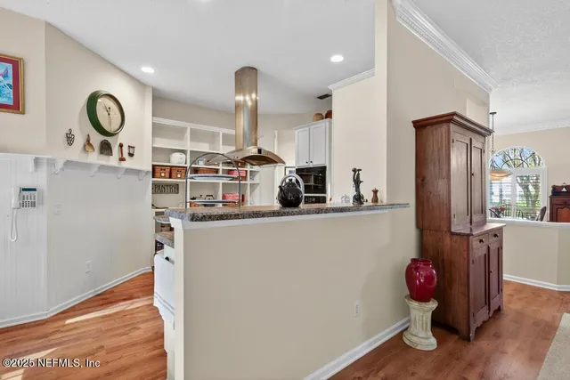 a kitchen with stainless steel appliances granite countertop a stove and a refrigerator