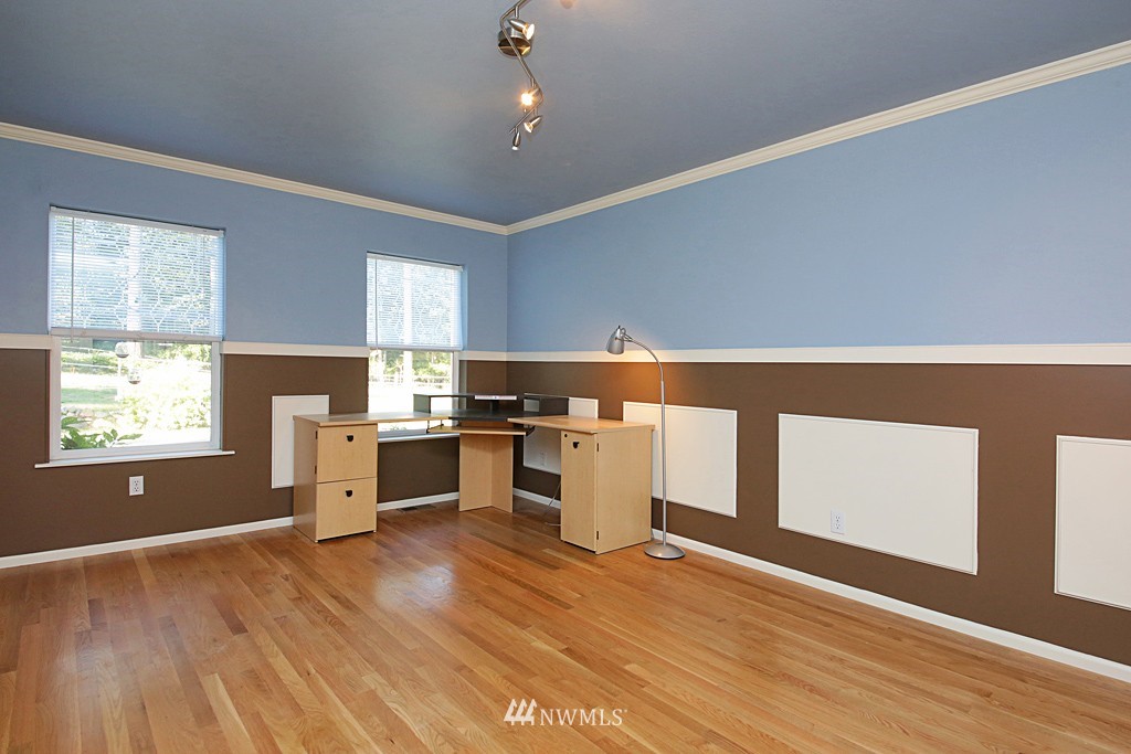 5723 Crow Haven Road Langley, WA 98260 - Photo 14 of 25 a kitchen with granite countertop a stove cabinets and wooden floor