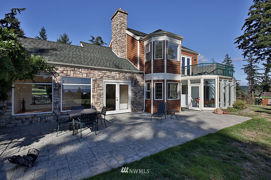 5723 Crow Haven Road Langley, WA 98260 - Photo 5 of 25 a front view of a house with a yard table and chairs