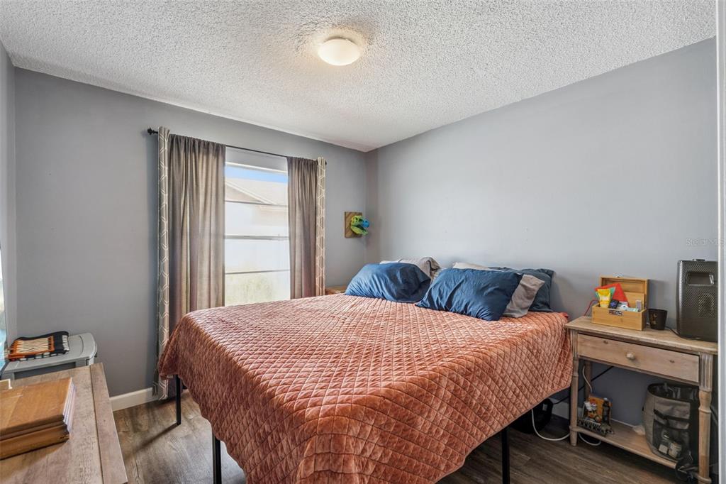 1070 Hali Ridge Court Kissimmee, FL 34747 - Photo 12 of 36 a bedroom with a bed and a window