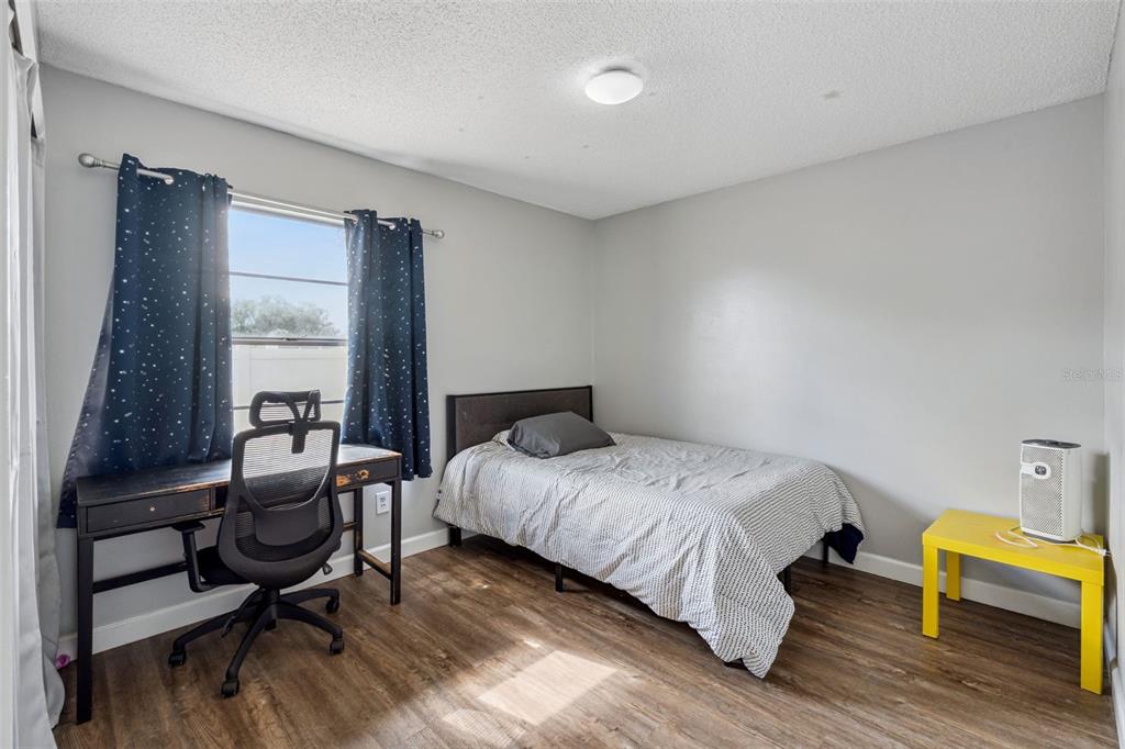 1070 Hali Ridge Court Kissimmee, FL 34747 - Photo 13 of 36 a bedroom with a bed and wooden floor