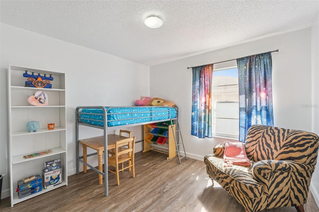 1070 Hali Ridge Court Kissimmee, FL 34747 - Photo 14 of 36 a living room with furniture and a wooden floor