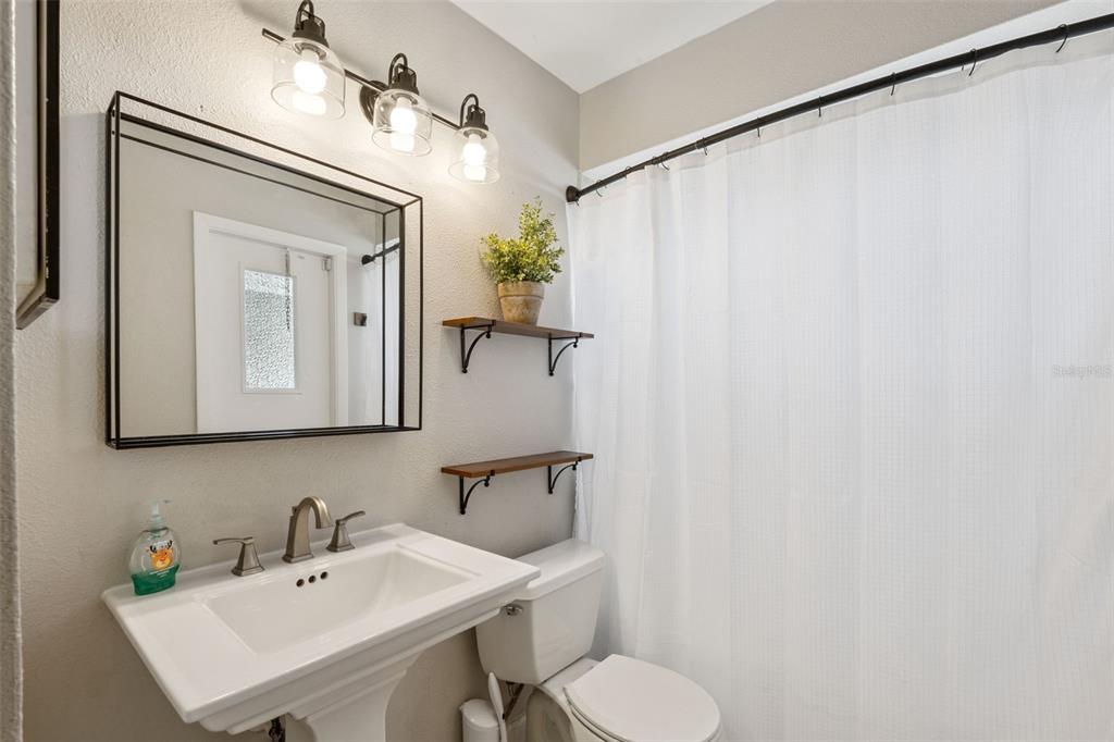 1070 Hali Ridge Court Kissimmee, FL 34747 - Photo 15 of 36 a bathroom with a sink mirror and toilet