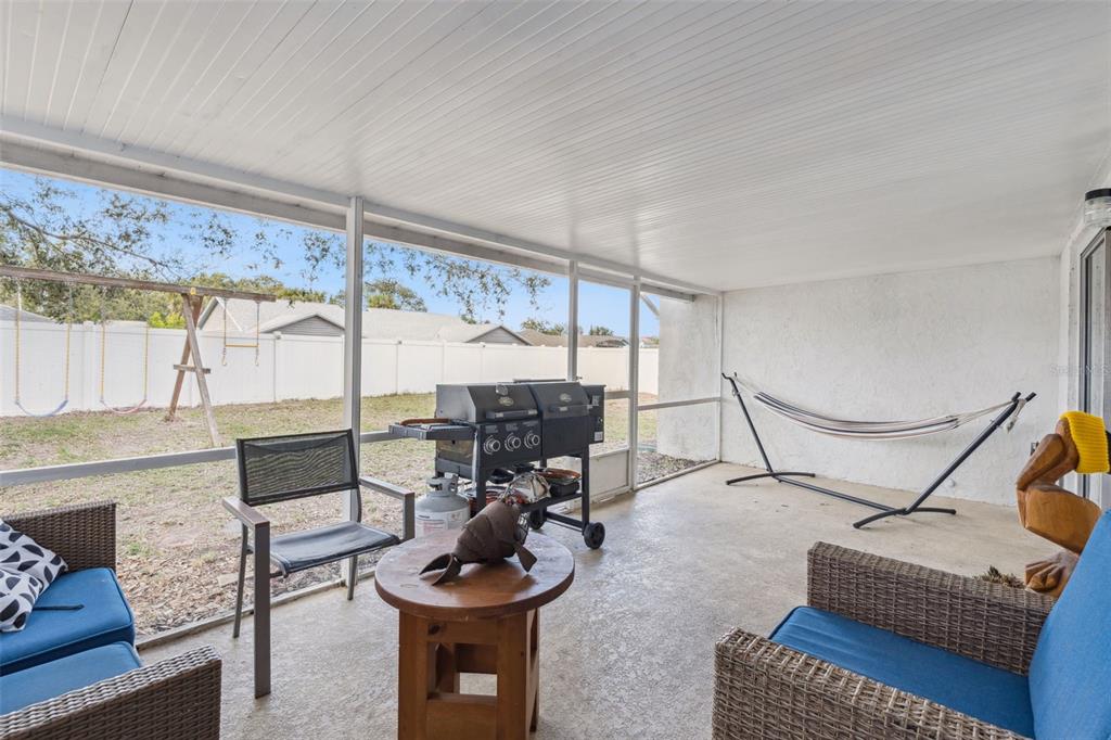 1070 Hali Ridge Court Kissimmee, FL 34747 - Photo 18 of 36 a living room with furniture a rug and a floor to ceiling window