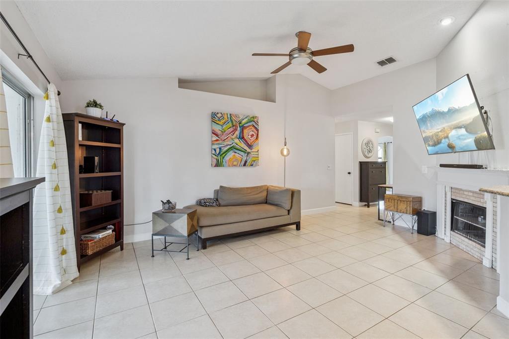 1070 Hali Ridge Court Kissimmee, FL 34747 - Photo 4 of 36 a living room with furniture and a flat screen tv