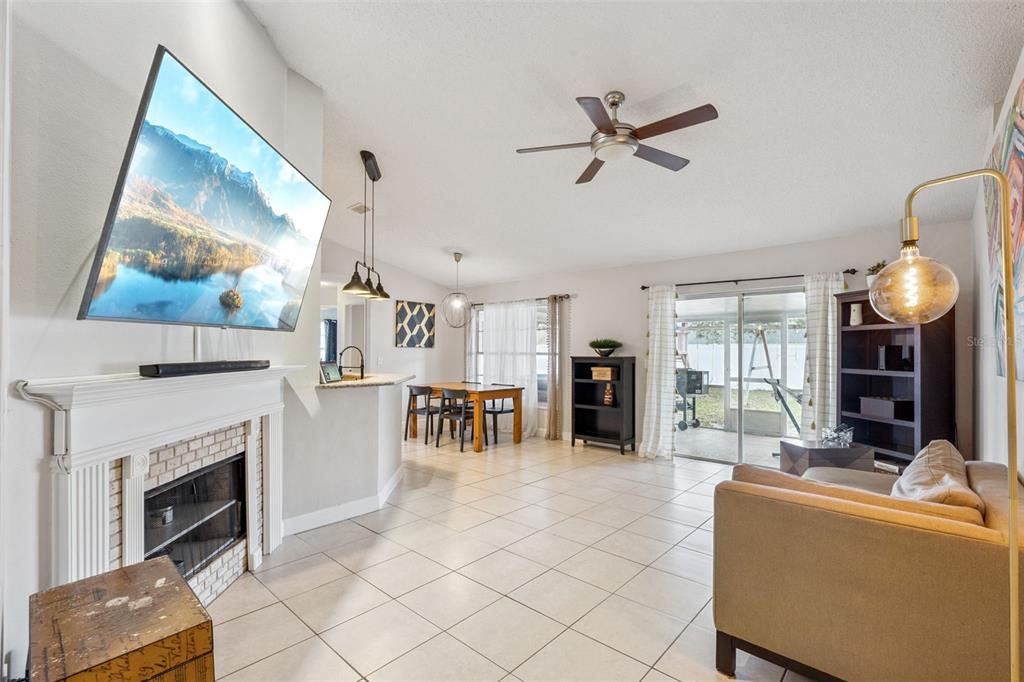 1070 Hali Ridge Court Kissimmee, FL 34747 - Photo 5 of 36 a living room with furniture and a fireplace
