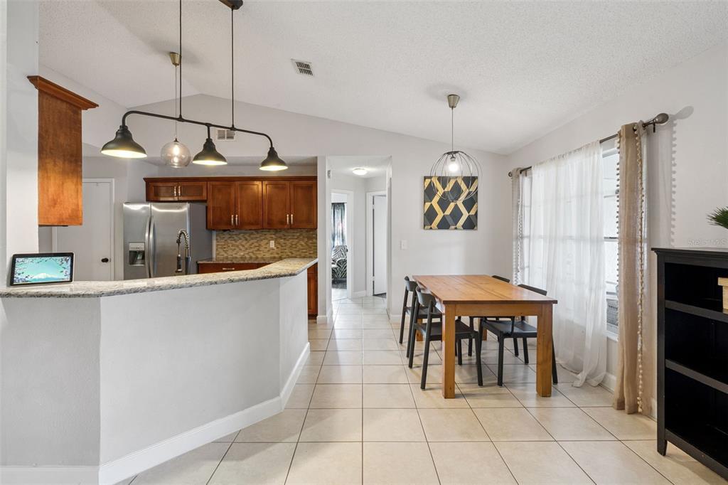 1070 Hali Ridge Court Kissimmee, FL 34747 - Photo 6 of 36 a kitchen with granite countertop a stove a sink and a refrigerator