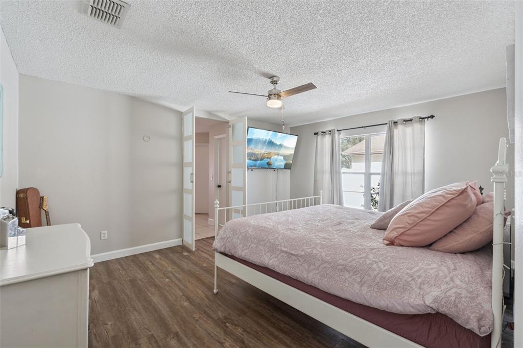 1070 Hali Ridge Court Kissimmee, FL 34747 - Photo 8 of 36 a bedroom with a large bed and a window