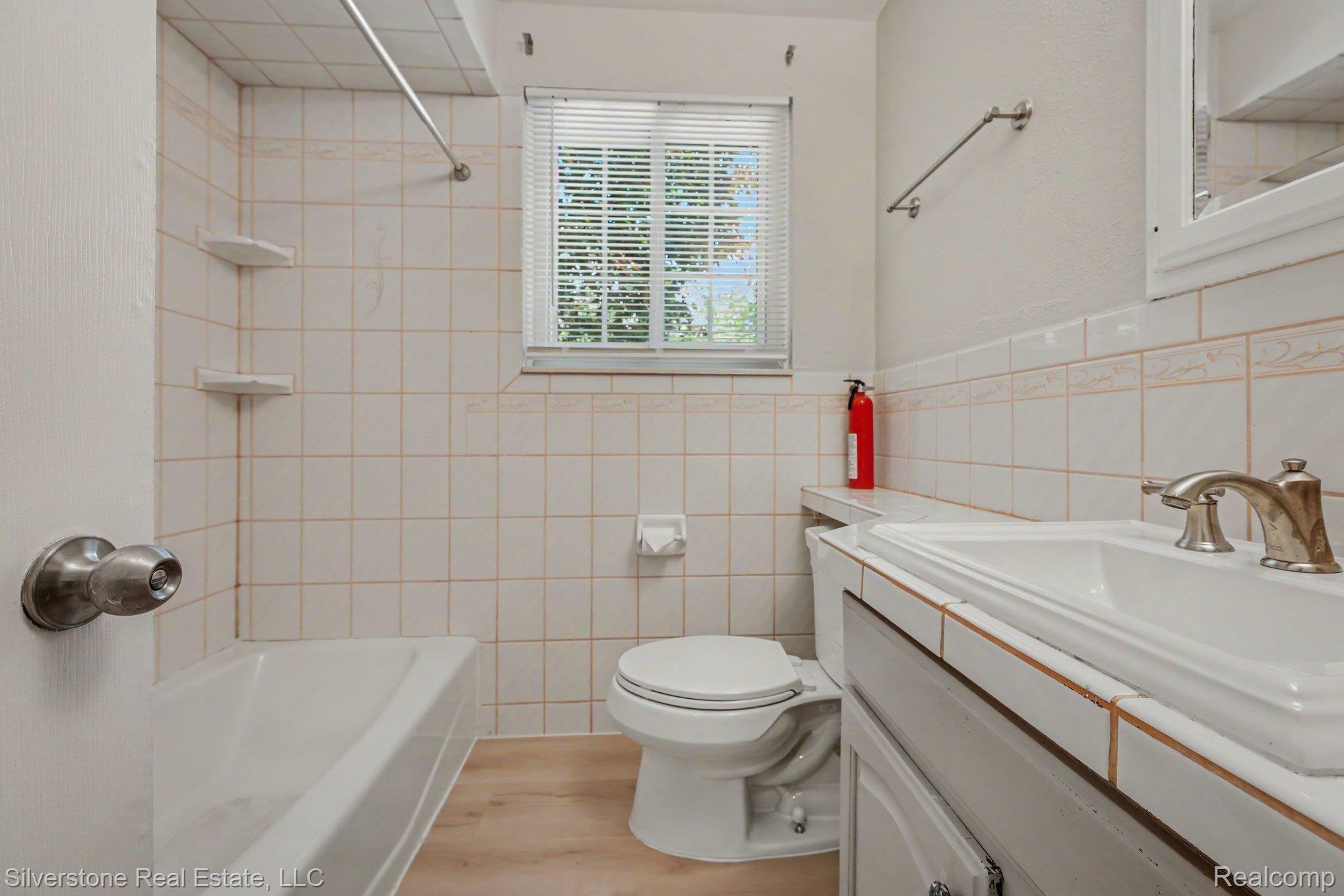 547 Reed Street Northville, MI 48167 - Photo 25 of 38 Bathroom featuring a built-in tub and shower combination with white tile surround