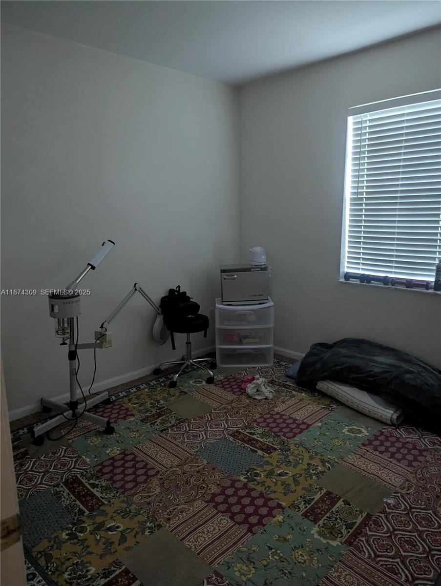 8496 Southwest 29th Street, Unit 104 Miramar, FL 33025 - Photo 12 of 19 a bedroom with a bed and a window