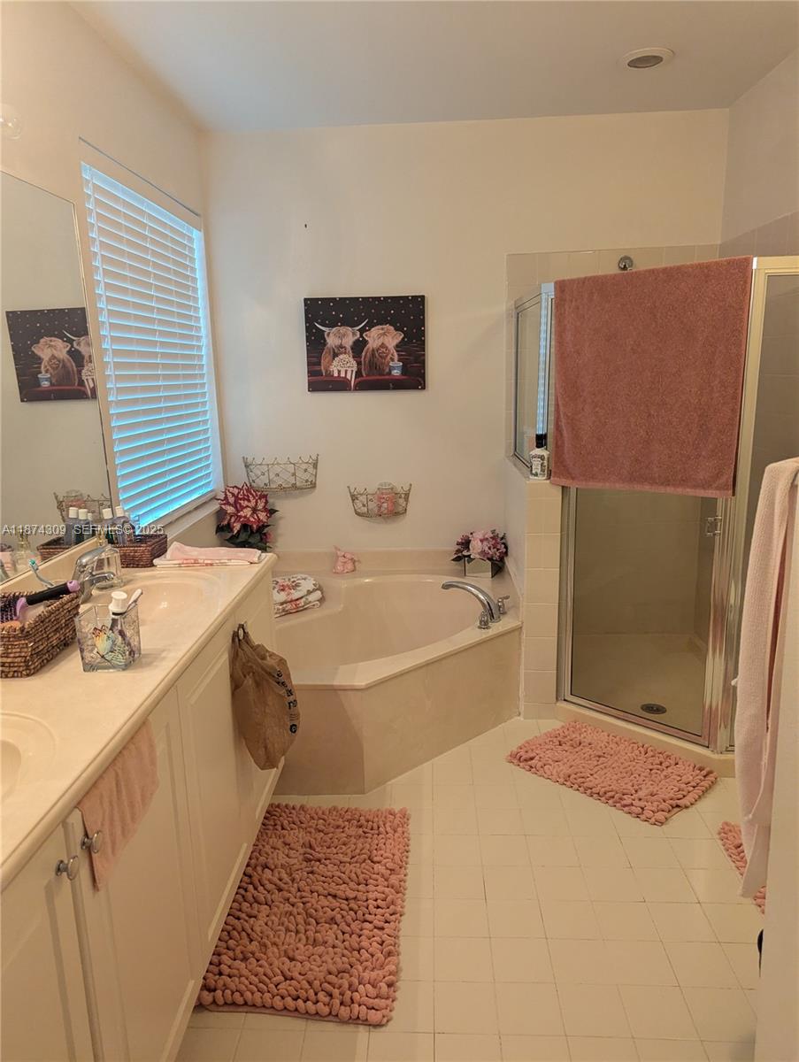 8496 Southwest 29th Street, Unit 104 Miramar, FL 33025 - Photo 13 of 19 a bathroom with a tub sink and mirror