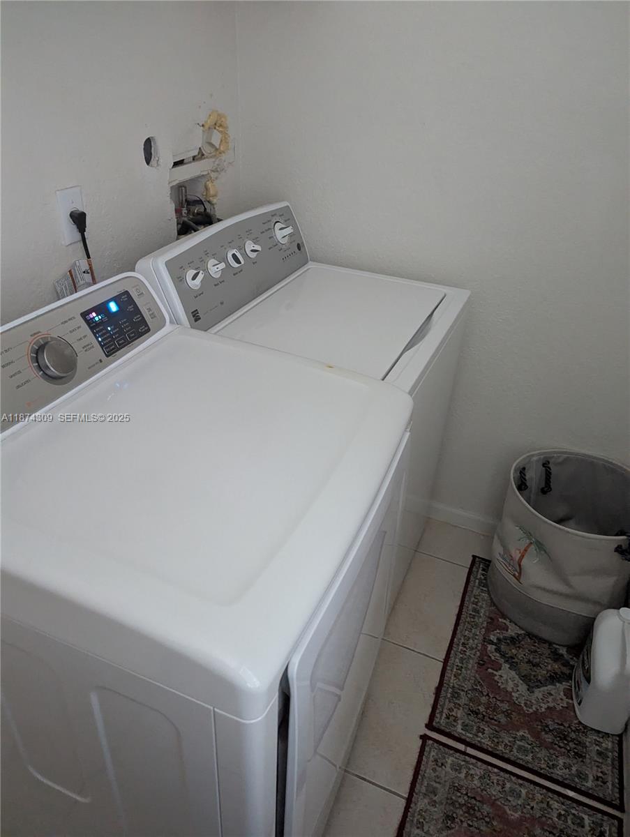 8496 Southwest 29th Street, Unit 104 Miramar, FL 33025 - Photo 5 of 19 a utility room with dryer and washer