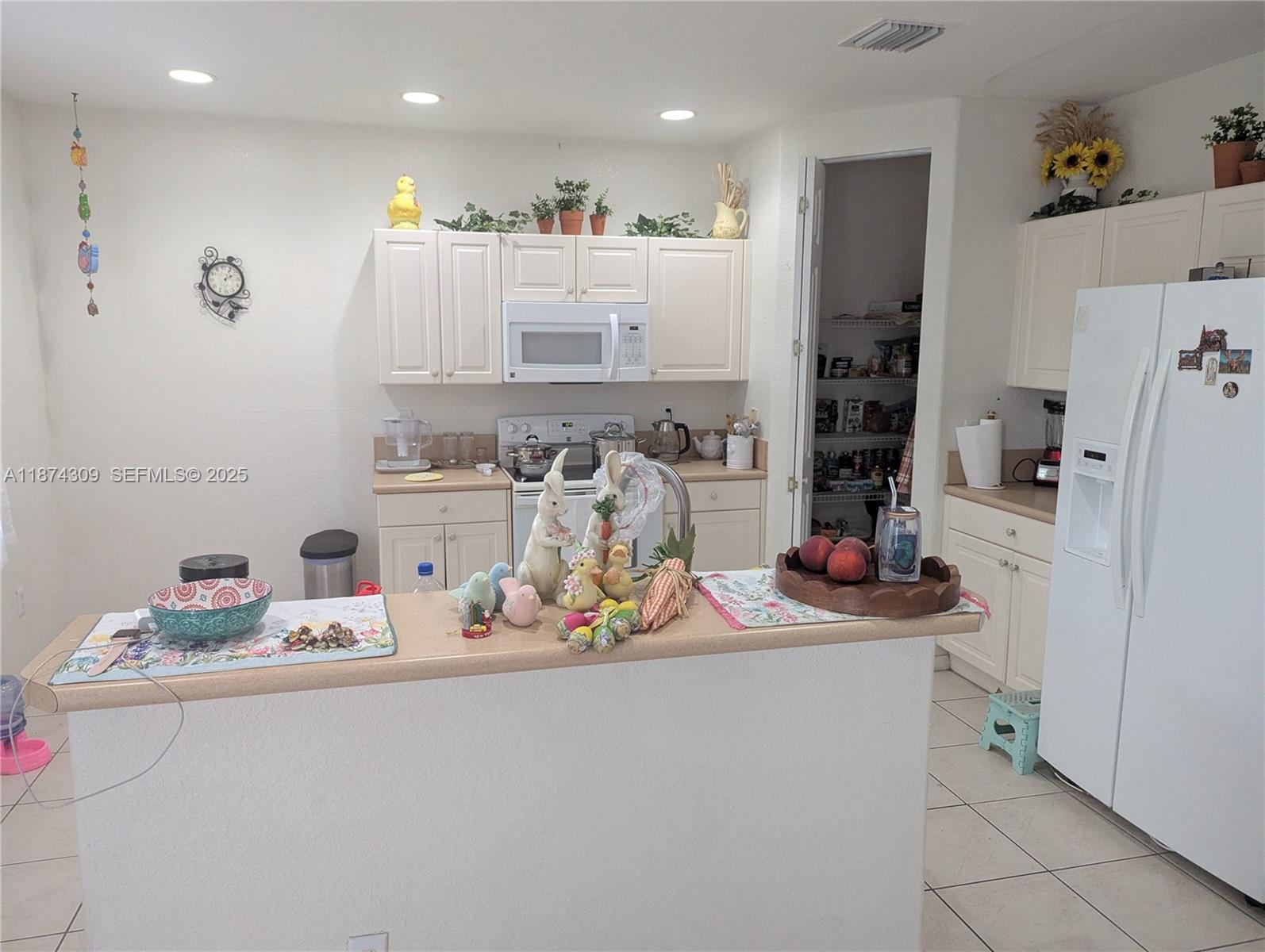 8496 Southwest 29th Street, Unit 104 Miramar, FL 33025 - Photo 8 of 19 a kitchen with refrigerator and cabinets