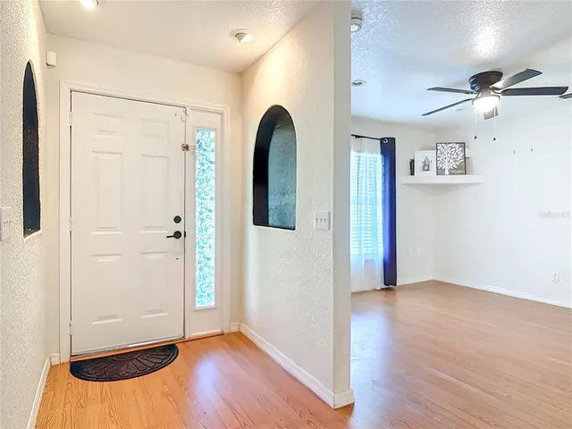 a view of an empty room with wooden floor
