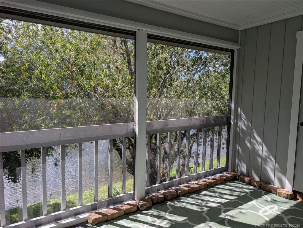 8291 Southeast Croft Circle, Unit M8 Hobe Sound, FL 33455 - Photo 12 of 22 a view of a balcony with wooden floor