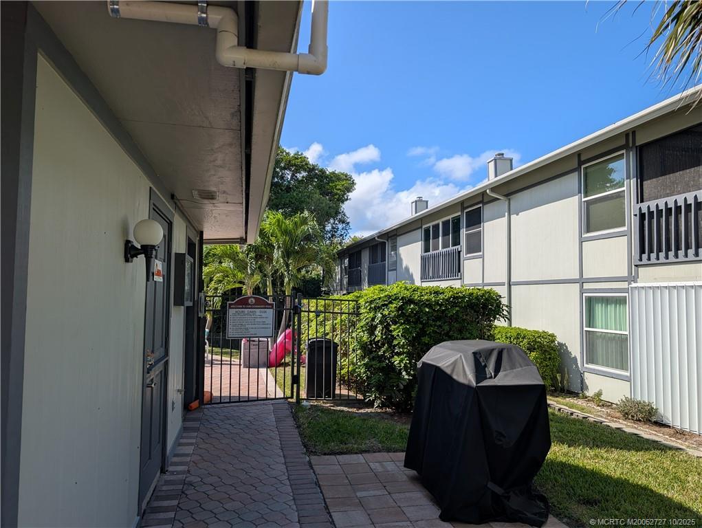 8291 Southeast Croft Circle, Unit M8 Hobe Sound, FL 33455 - Photo 17 of 22 a front view of a house with garden