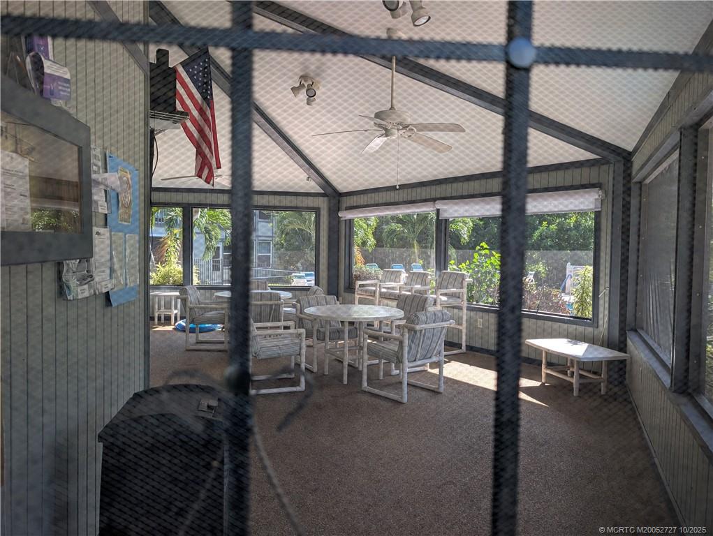 8291 Southeast Croft Circle, Unit M8 Hobe Sound, FL 33455 - Photo 19 of 22 a living room with furniture and a large window
