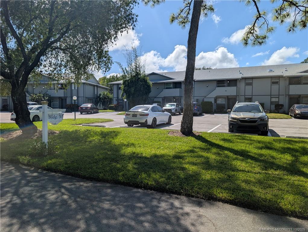 8291 Southeast Croft Circle, Unit M8 Hobe Sound, FL 33455 - Photo 2 of 22 a view of a house with backyard porch and sitting area