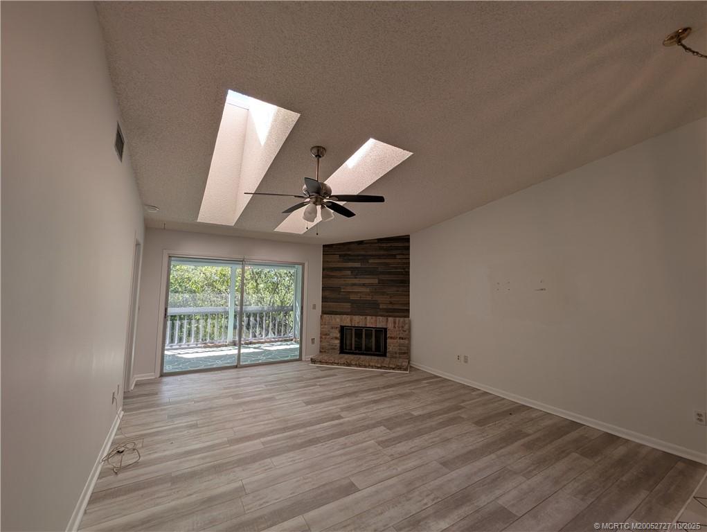 8291 Southeast Croft Circle, Unit M8 Hobe Sound, FL 33455 - Photo 4 of 22 wooden floor in an empty room with a window
