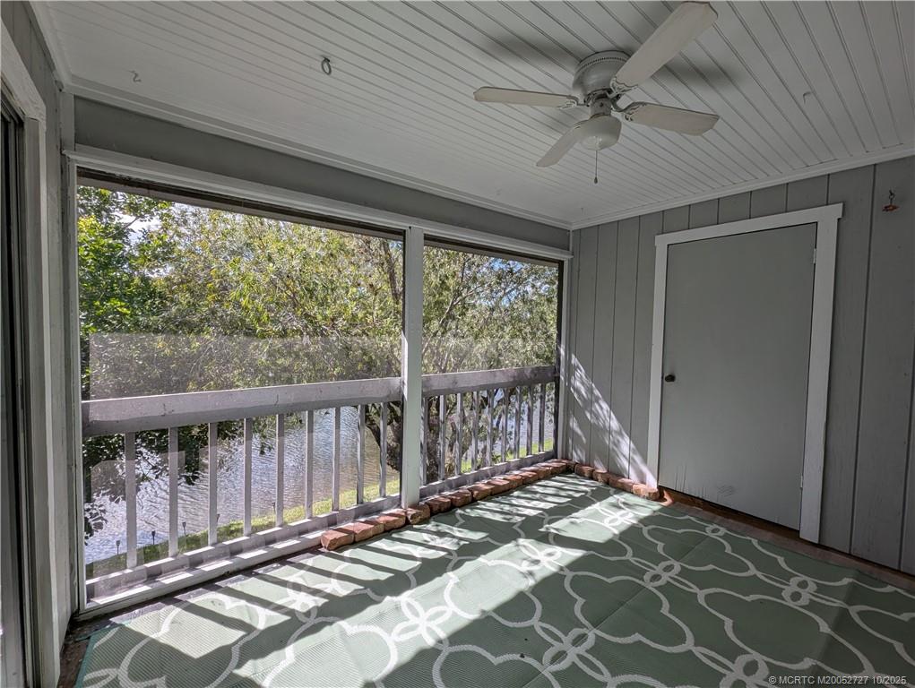 8291 Southeast Croft Circle, Unit M8 Hobe Sound, FL 33455 - Photo 6 of 22 a view of a porch with wooden floor