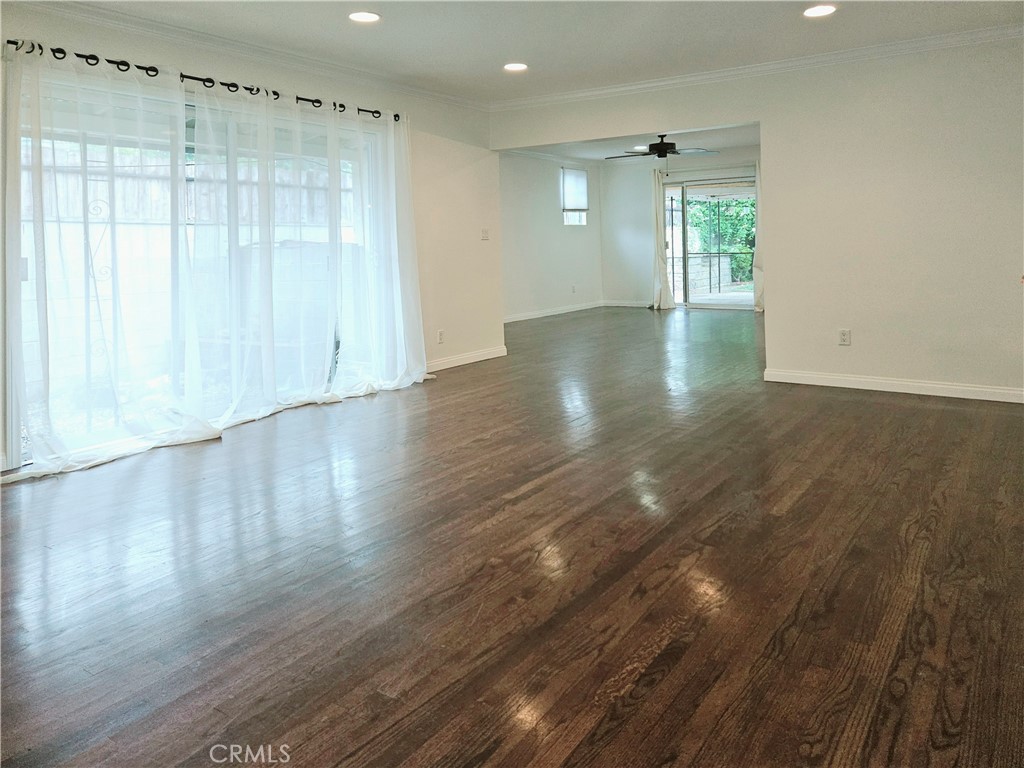 17501 Hamlin Street Lake Balboa, CA 91406 - Photo 10 of 26 a view of an empty room with wooden floor and a window