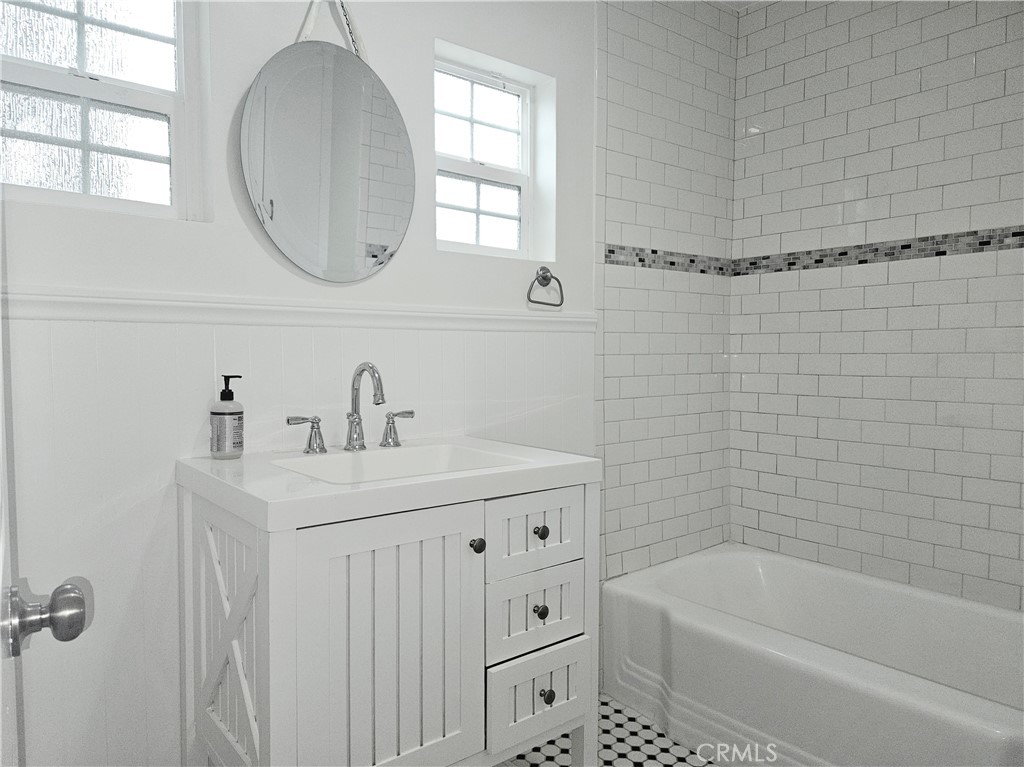 17501 Hamlin Street Lake Balboa, CA 91406 - Photo 11 of 26 a bathroom with a sink a toilet and bathtub