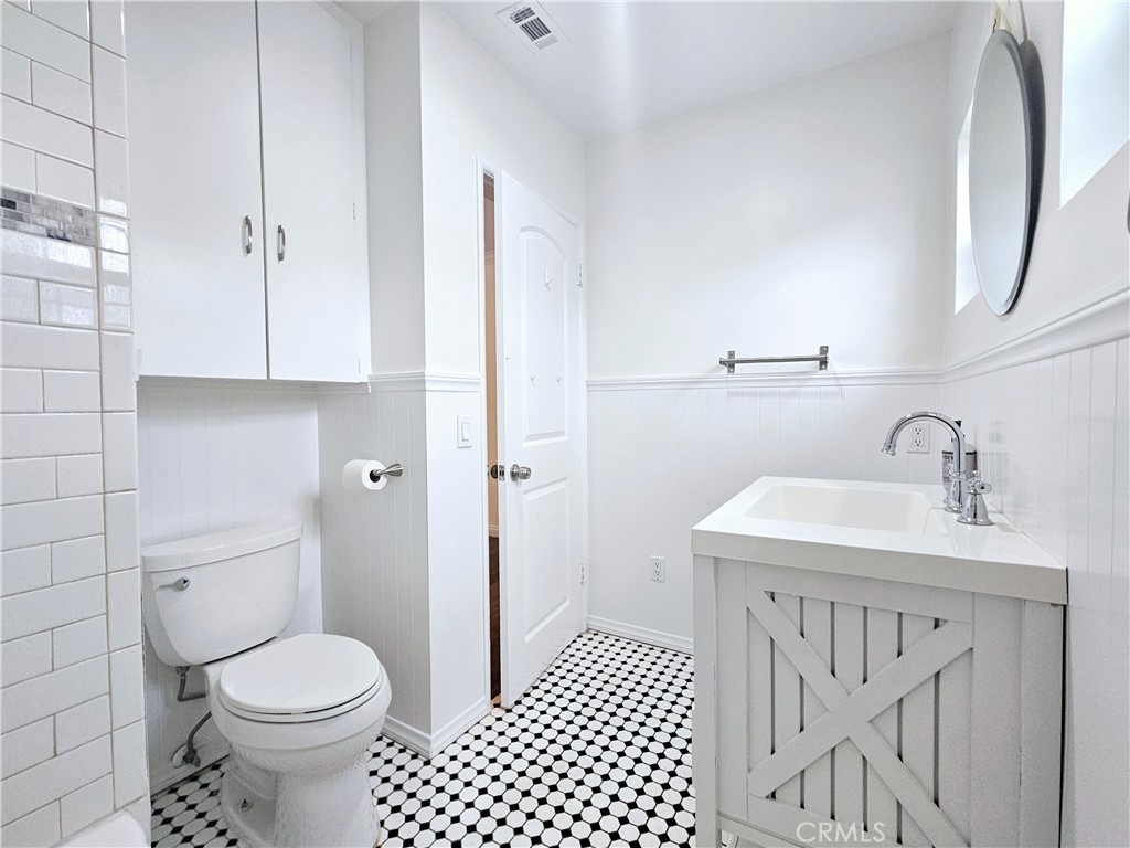 17501 Hamlin Street Lake Balboa, CA 91406 - Photo 12 of 26 a bathroom with a sink toilet and a mirror