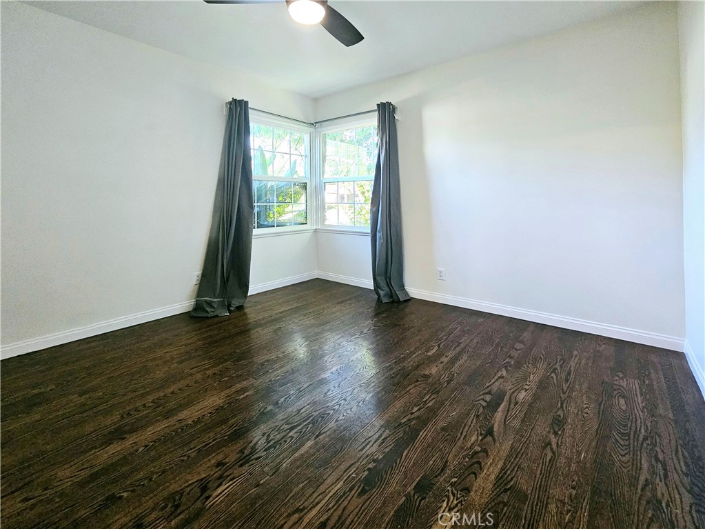 17501 Hamlin Street Lake Balboa, CA 91406 - Photo 13 of 26 an empty room with wooden floor and windows