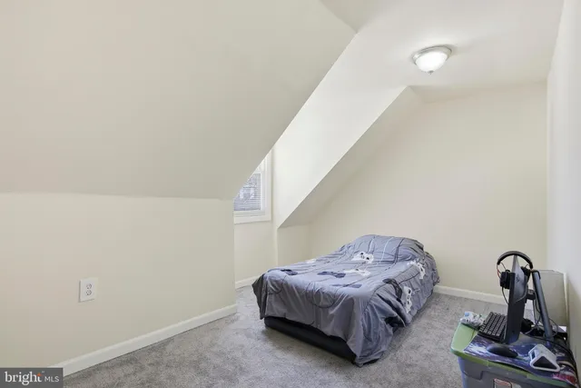 a bedroom with a bed and a window with the shoe rack