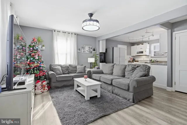 a living room with furniture and a chandelier