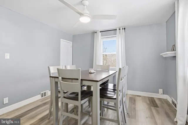 a view of a dining room with furniture and window