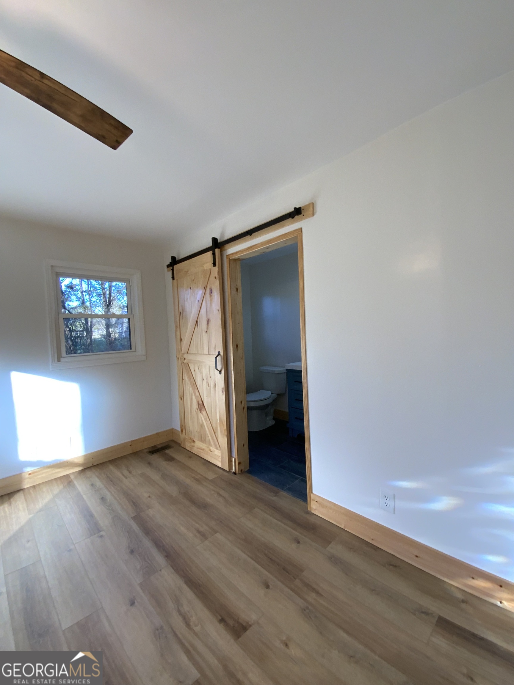 5569 Fosters Mill Road Cave Spring, GA 30124 - Photo 13 of 19 a view of an empty room with wooden floor and a window