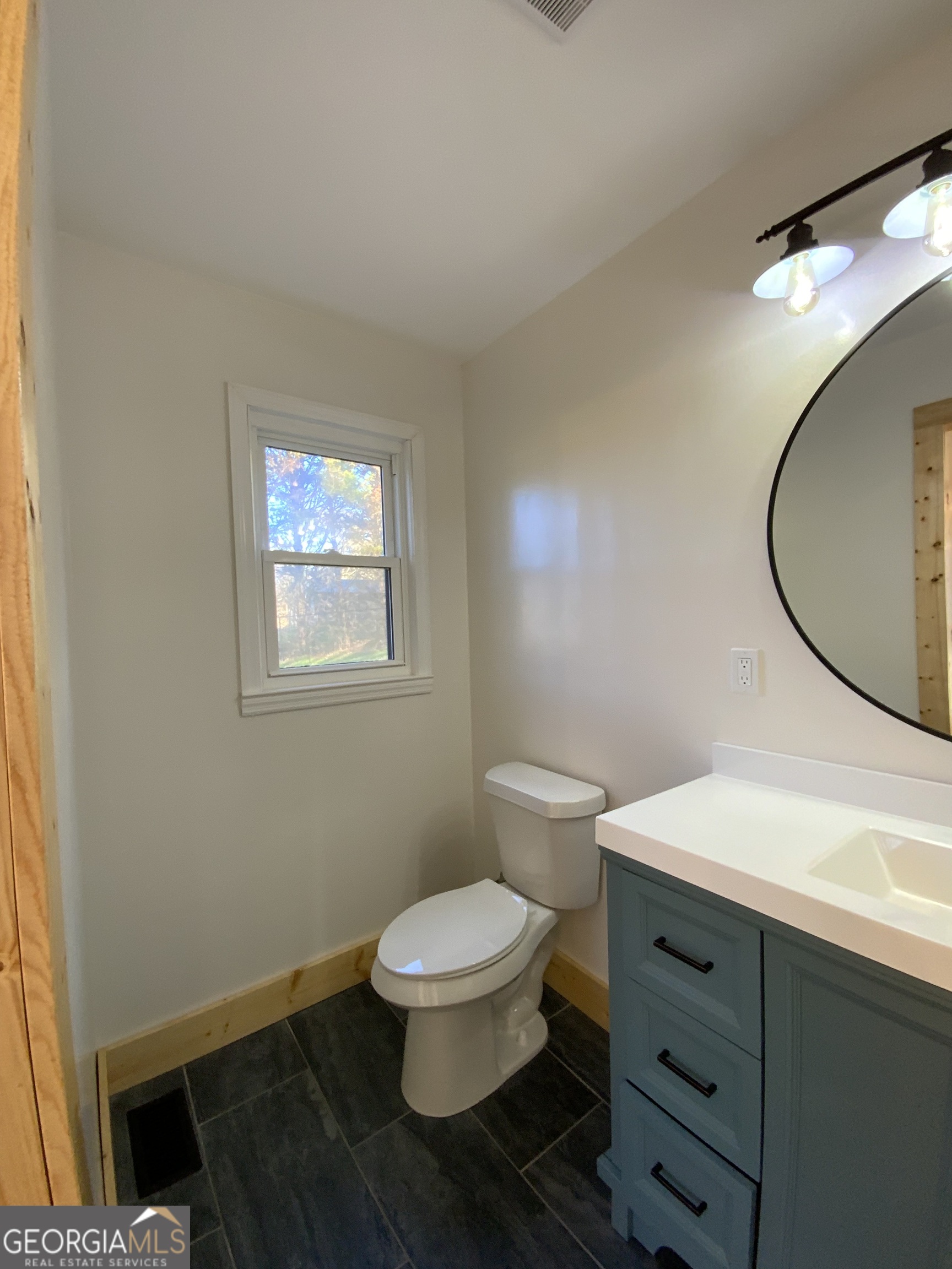5569 Fosters Mill Road Cave Spring, GA 30124 - Photo 14 of 19 a bathroom with a toilet a sink and mirror