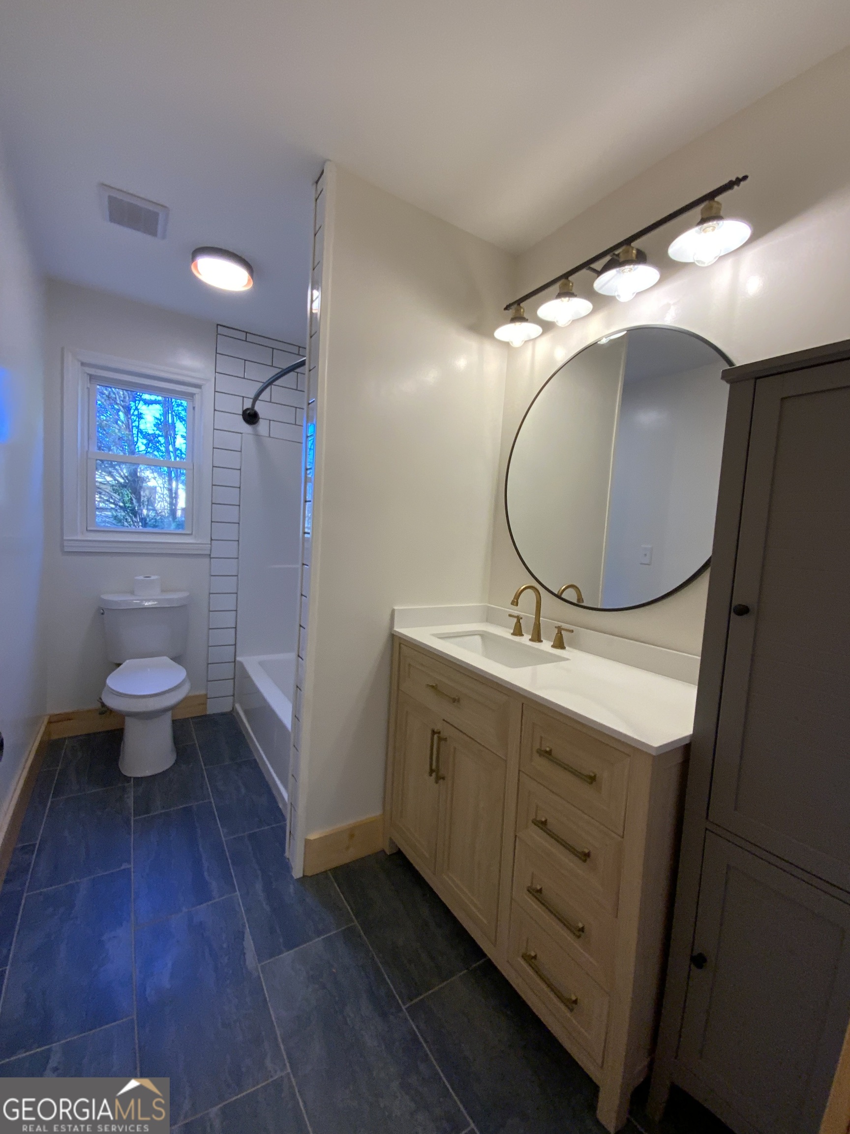 5569 Fosters Mill Road Cave Spring, GA 30124 - Photo 19 of 19 a bathroom with a sink and a mirror