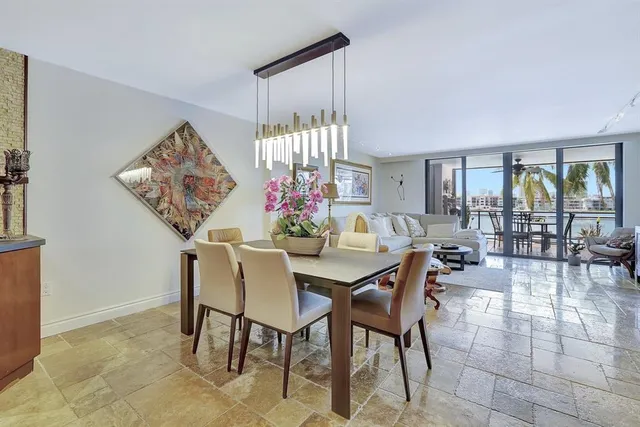 a dining room with furniture a chandelier and fireplace
