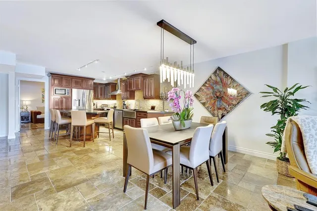 a living room with furniture a rug and a floor to ceiling window