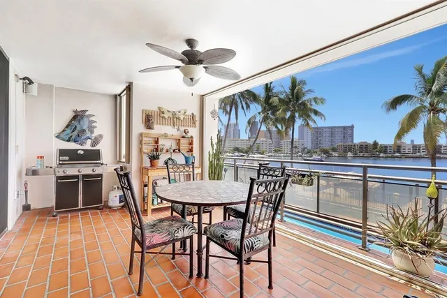 a view of swimming pool with outdoor seating and plants