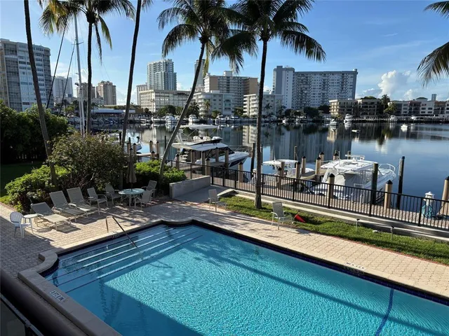 a bathroom with a granite countertop toilet sink and mirror