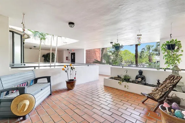 a open kitchen with stainless steel appliances kitchen island granite countertop a table and chairs in it