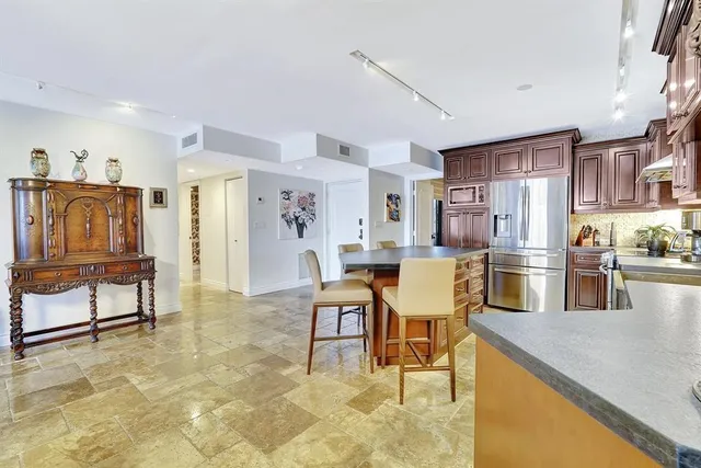 a kitchen with granite countertop cabinets and refrigerator