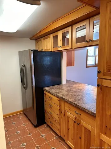 a kitchen with stainless steel appliances granite countertop a refrigerator and a stove