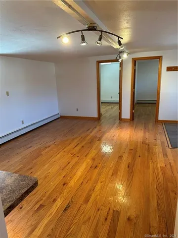 a view of a room with wooden floor