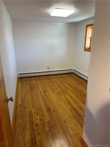 a view of a room with wooden floor and bathroom
