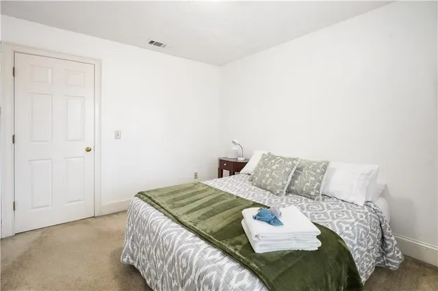 a bedroom with a bed and a table